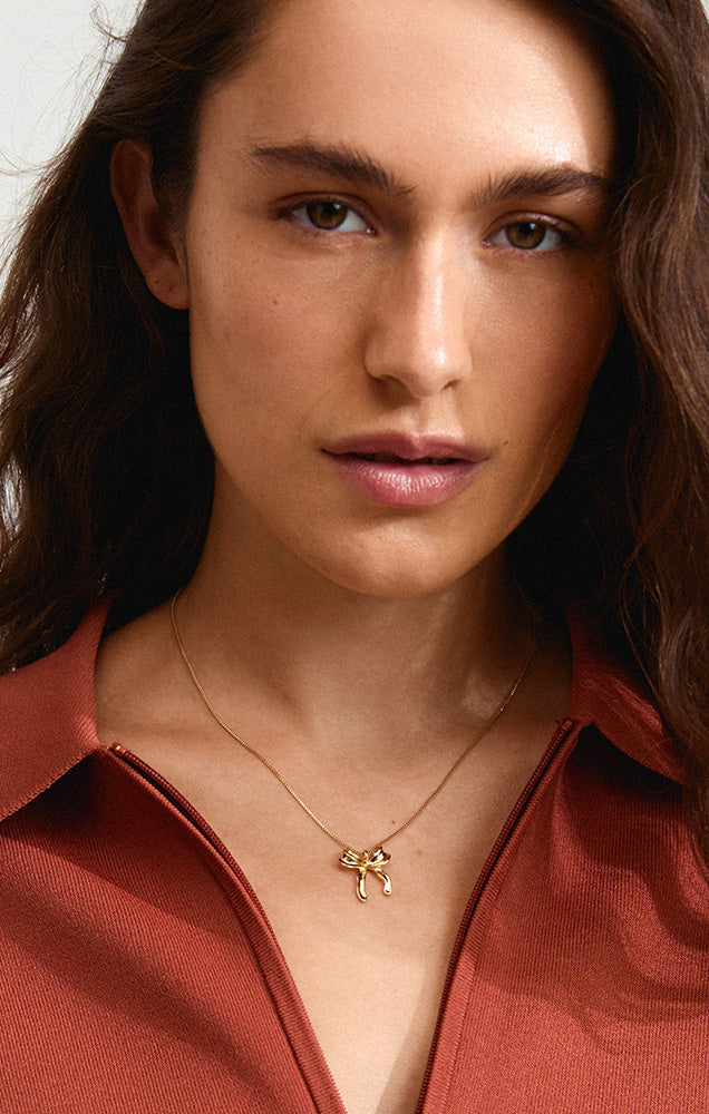 PILGRIM CASSIAN RECYCLED BOW PENDANT NECKLACE IN GOLD